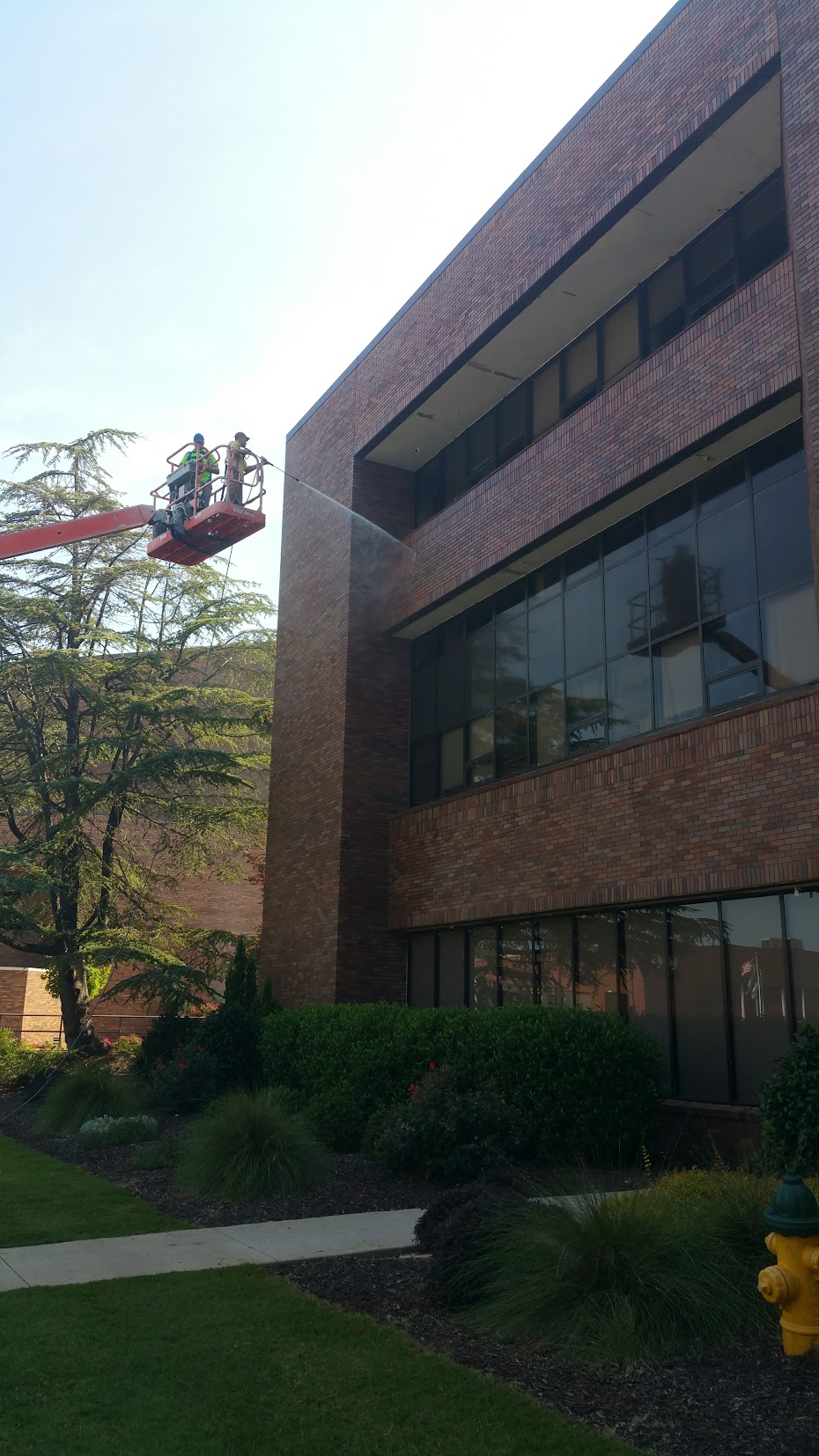 Commercial building exterior cleaning from boom lift