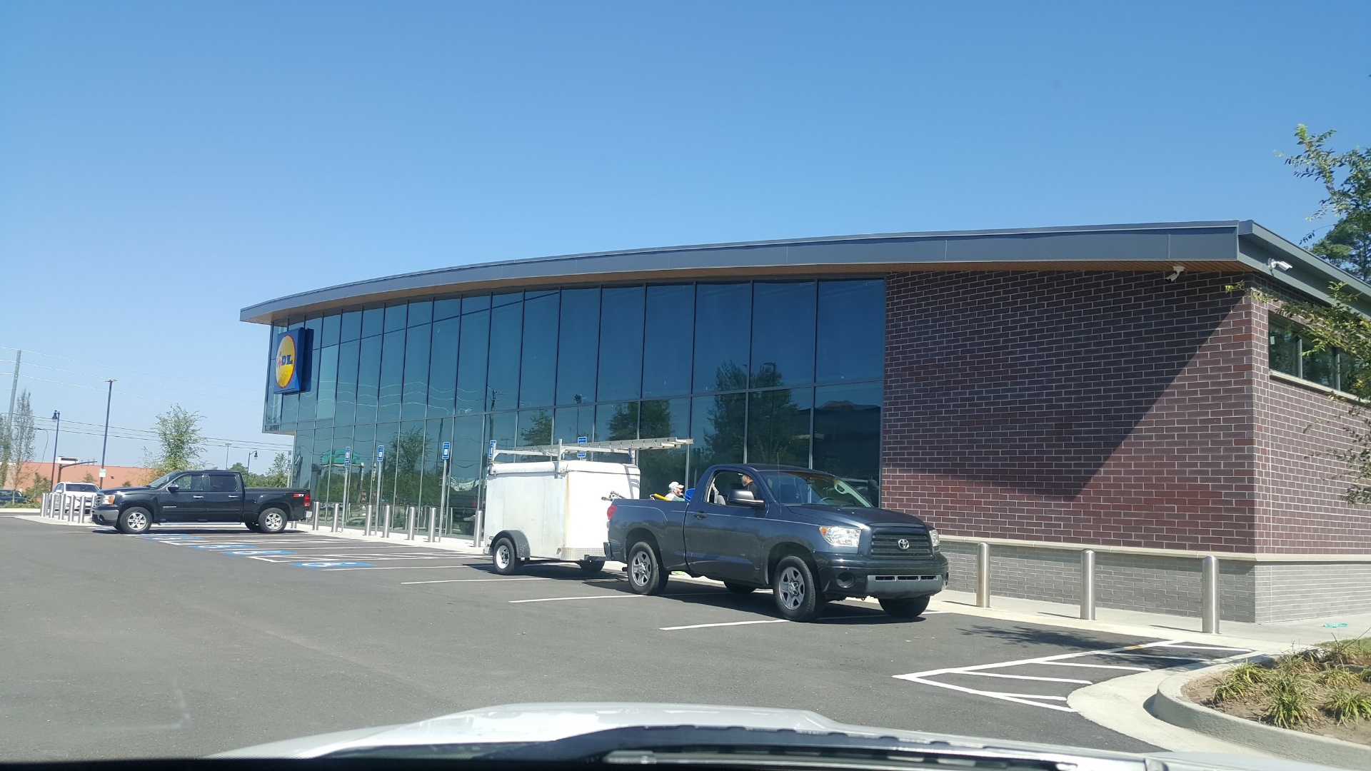 Commercial storefront window cleaning truck on-site