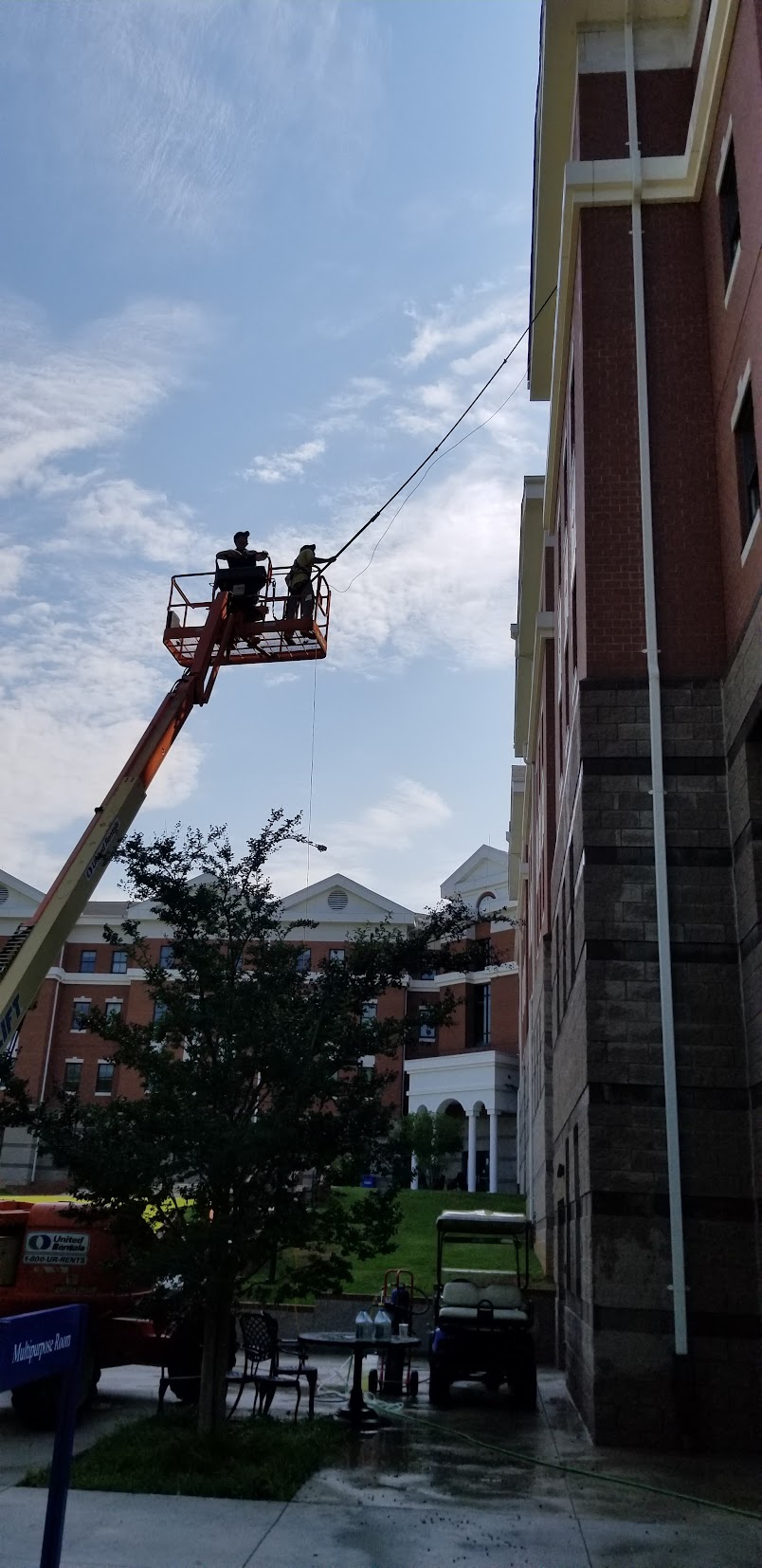 High-rise window cleaning with boom lift
